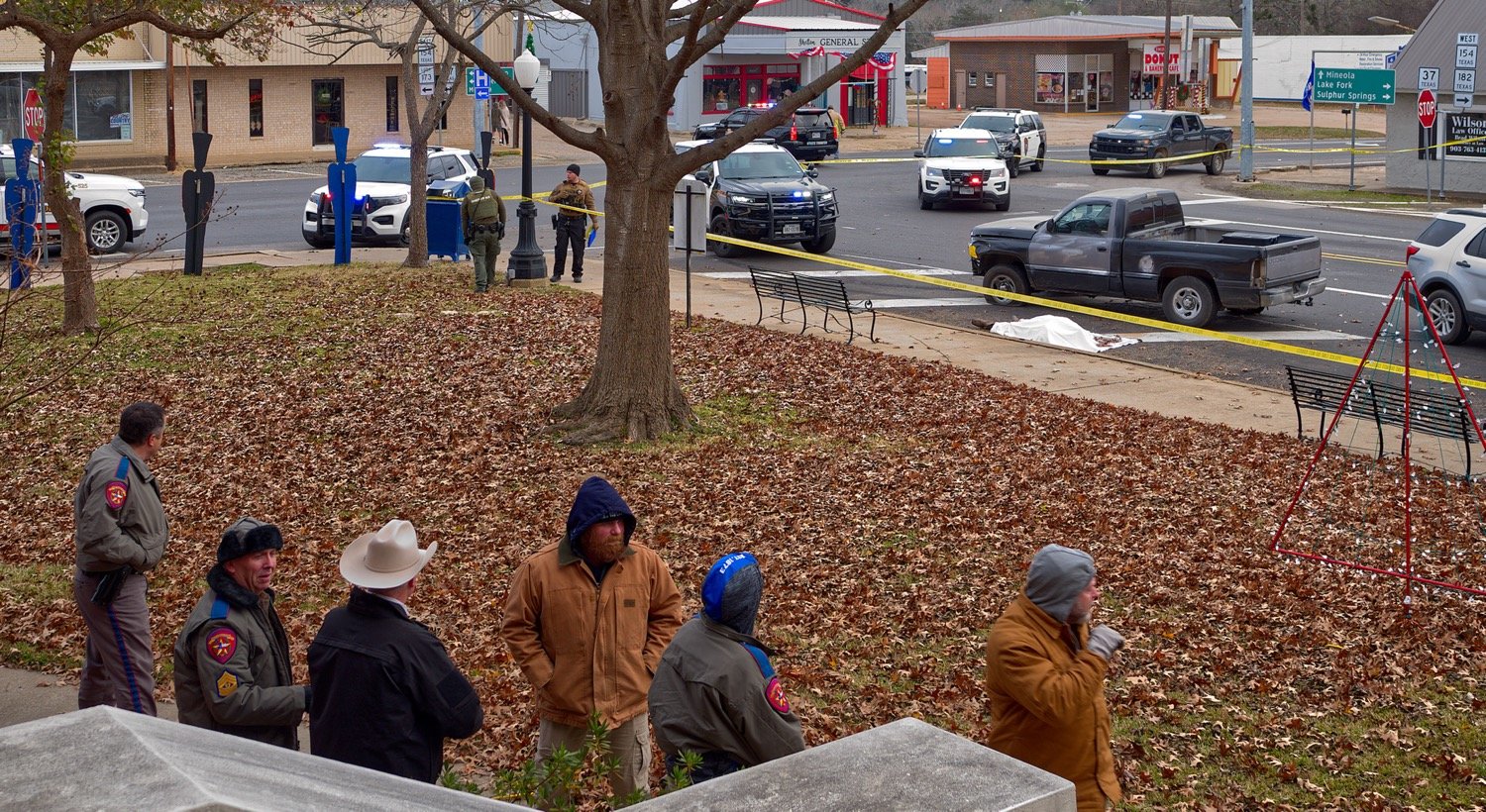 Officers from multiple agencies stand by for processing of the crime scene of a fatal shooting Thursday afternoon in downtown Quitman. [view more from scene]